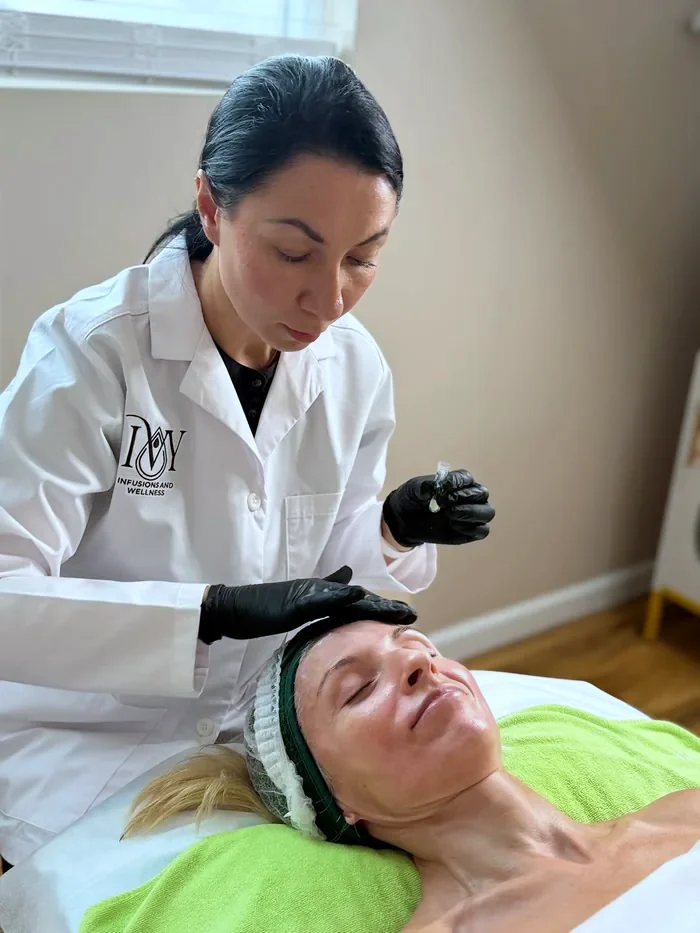 A licensed esthetician performing a facial treatment at the practice
